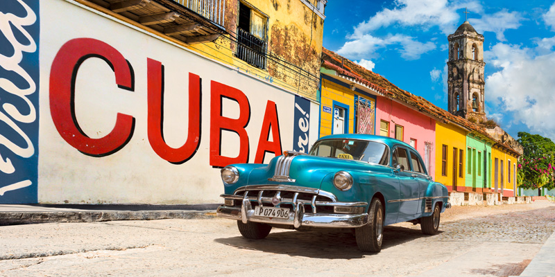 Pangea Images, Vintage car and mural, Cuba