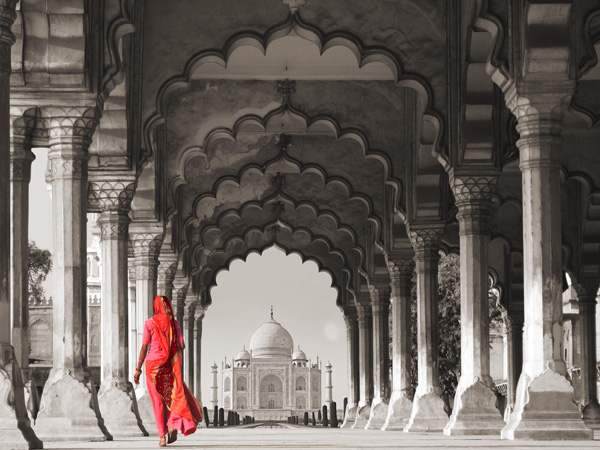 Pangea Images, Woman in traditional Sari walking towards Taj Mahal (BW)